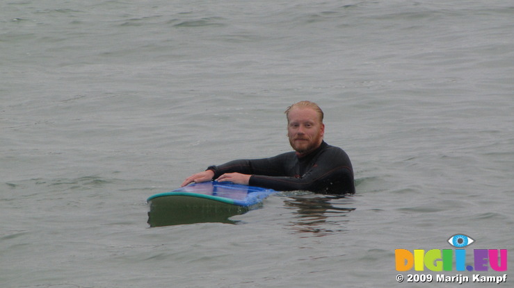 SX08860 Marijn with surfboard at Porth Beach, Newquay